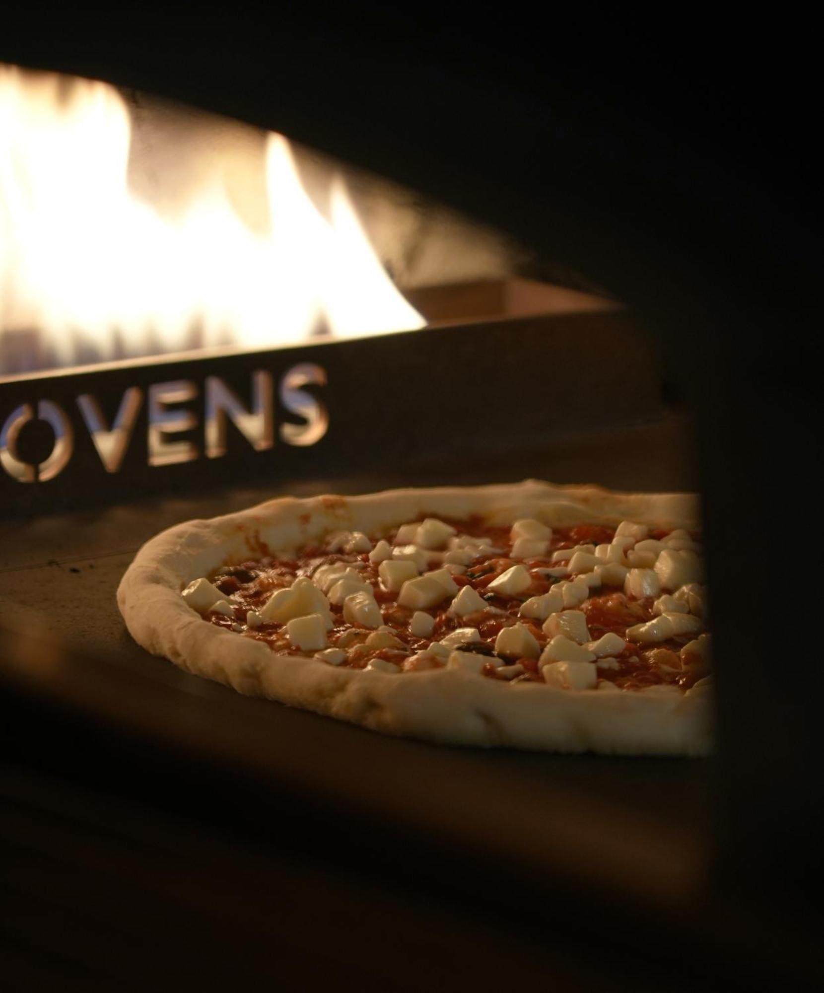 Fairmont Riyadh Exterior photo A pizza in a wood-fired oven